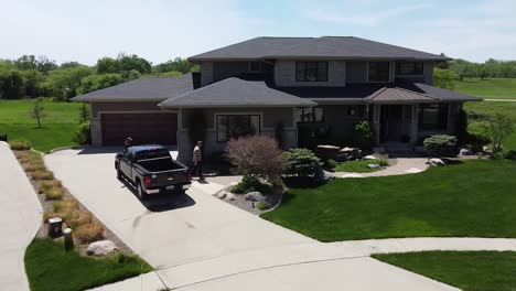 Drone-push-in-on-a-home-improvement-crew-getting-out-of-a-truck-with-tools