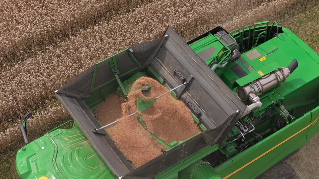Modern farming industry scene, combine and straw rows in action, Netherlands