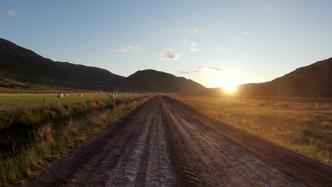 Golden-sunrise-at-rural-road-and-hay-fields