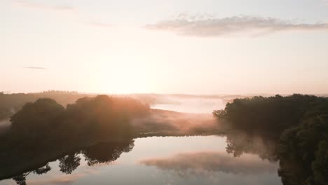 misty sunrise over a forest lake