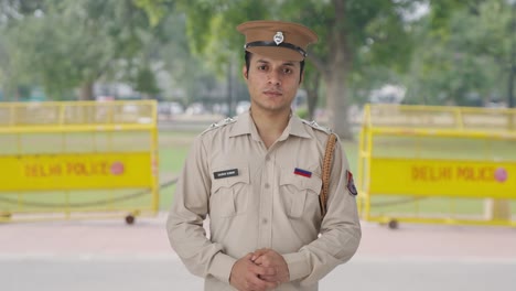 serious indian police officer looking to the camera