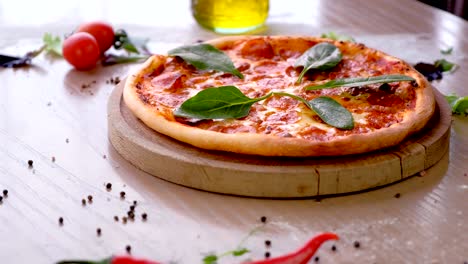 cook puts spinach leaves on pizza salami hands in rubber gloves.