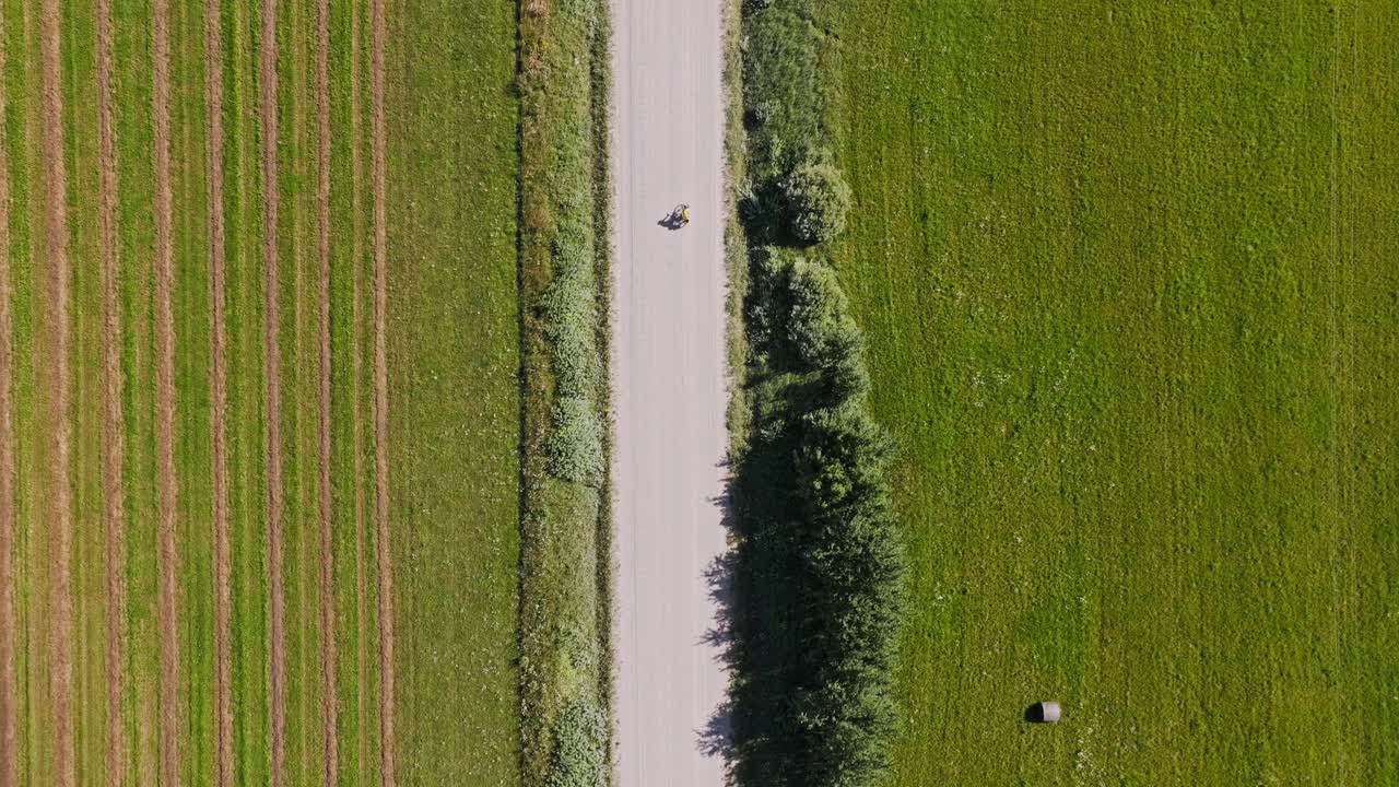 Aerial top view of countryside cycling evokes leisure, exploration and escape