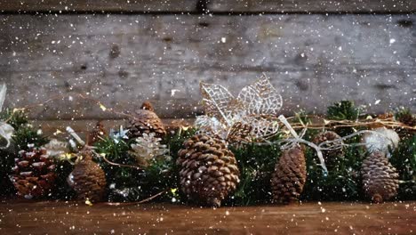 Video-composition-with-falling-snow-over-desk-with-many-pine-cones