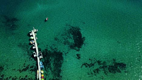 drone shooting with clear turquoise water of the mediterranean sea, the camera goes up