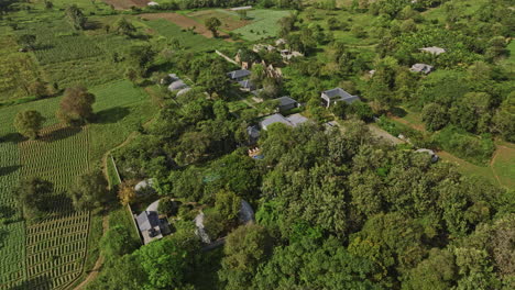 sigiriya sri lanka aerial v2 birds eye view flyover and around resort hotel surrounded by lush tress, tilt up reveals beautiful landscape of countryside farmlands - shot with mavic 3 cine - april 2023