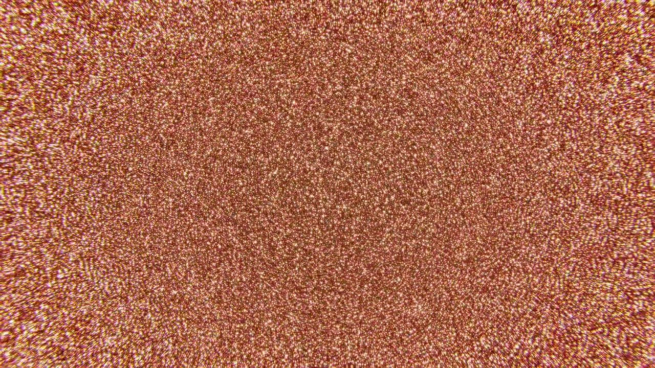 Texture glitterata oro rosa che riempie l'inquadratura con dense particelle metalliche e calde tonalità rame, scintillante