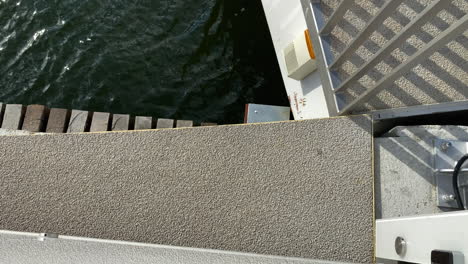 sliding pedestrian bridge over motlawa river in poland - overhead shot