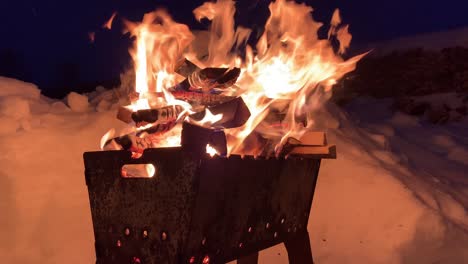 stacked firewood on the grill burns well and brightly at night.