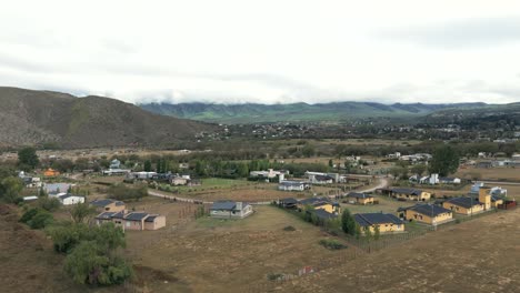 Truck-drone-shot-of-building-area-in-the-Province-of-Tucuman-on-a-cloudy-day-in-slow-motion,-single-family-houses-with-copy-space