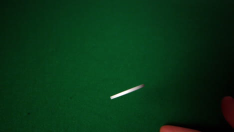 hand flipping white casino chip