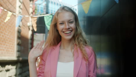 happy woman in pink blazer outdoors