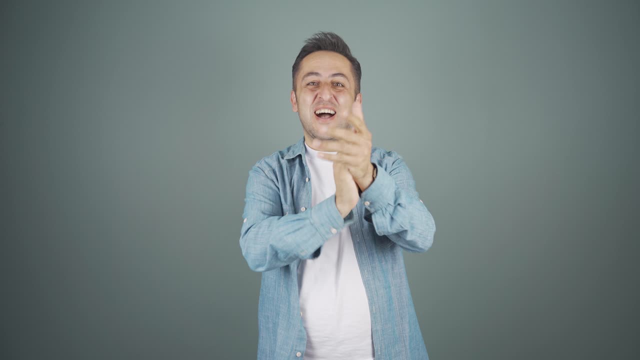 Man clapping excitedly to camera.
