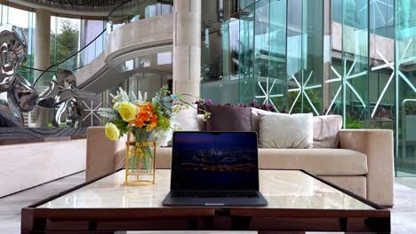 macbook displaying night skyline screensaver of dubai in luxurious house