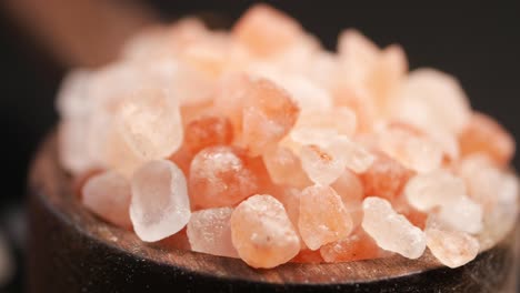 pink himalayan salt crystals in wooden bowl