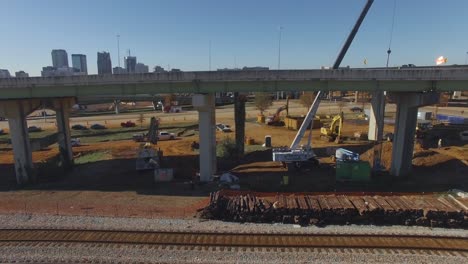 cars drive over busy city overpass during on ramp construction project