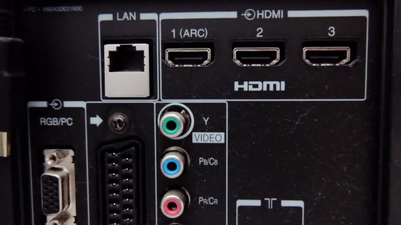 Close-up view of various input and output ports on the back panel of a TV