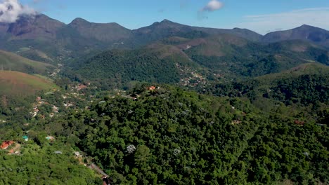 aerial flyover above houses in petrópolis, brazil, background mountain views.