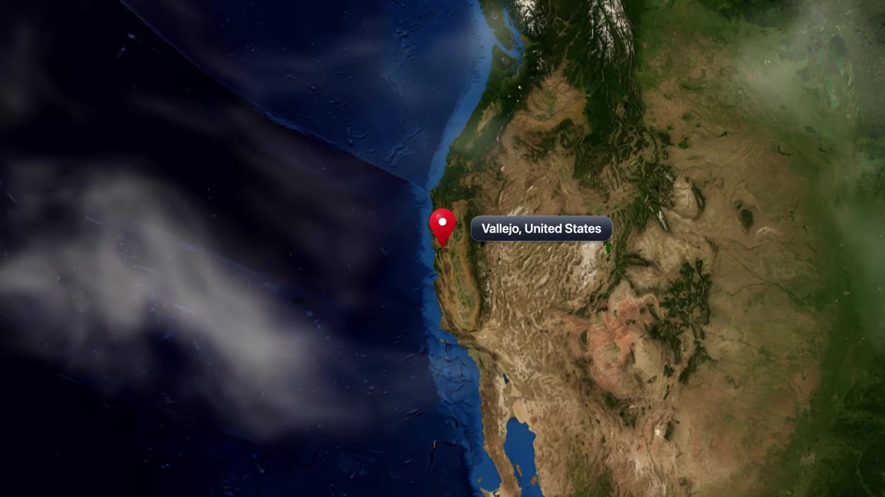 Satellite camera zooms from deep space into Vallejo, California, marking location with pin marker. Includes NASA public domain imagery.