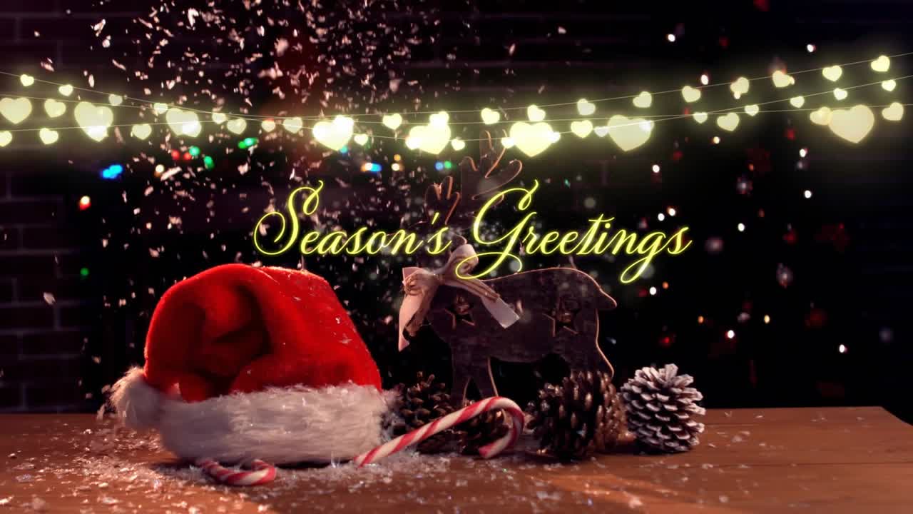 After stillness lights twinkling flakes drifting onto holiday objects as Season's Greetings fading