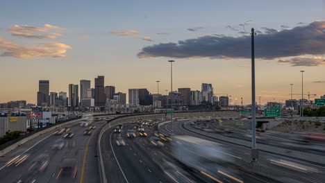 Time-lapse-day-to-night-of-busy-traffic-on-highway,-view-of-Denver-CBD-skyline