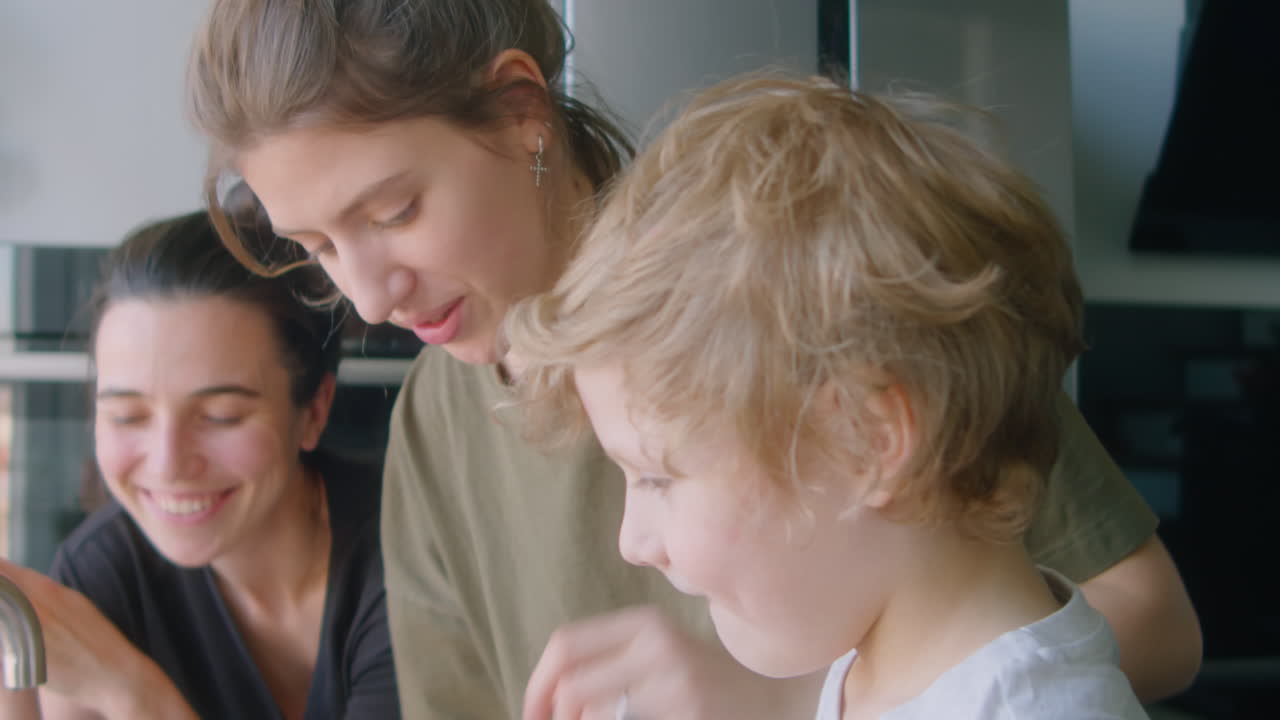 LGBTQ Family Doing Dishes Together at Home