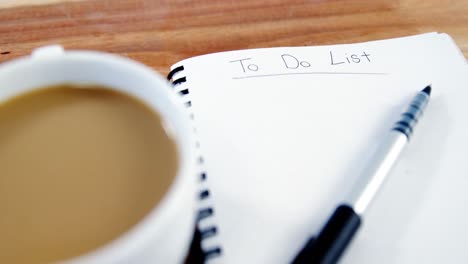 Cup-of-coffee-with-diary-and-pen