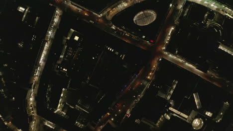 AERIAL:-Slow-Overhead-Shot-of-City-at-Night-with-Lights-and-Traffic,-Cologne,-Germany