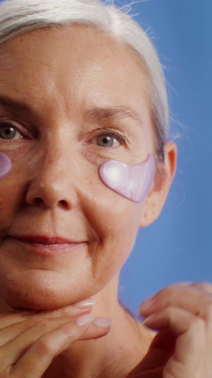 Mature Woman Applying Eye Patches for Skin Care