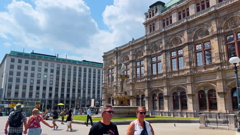 vienna, austria - june 9, 2025: pedestrian walk by the square in front of vienna state opera. view on the stunning façade of the beautiful historical building