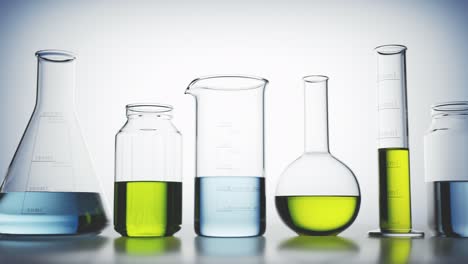 Seamless-looping-animation-of-laboratory-glassware-filled-with-colorful-liquids.-Multi-colored-light-passes-through-the-glass-beakers,-flasks-and-liquids-with-caustic-effect.-Concept-of-science,-lab