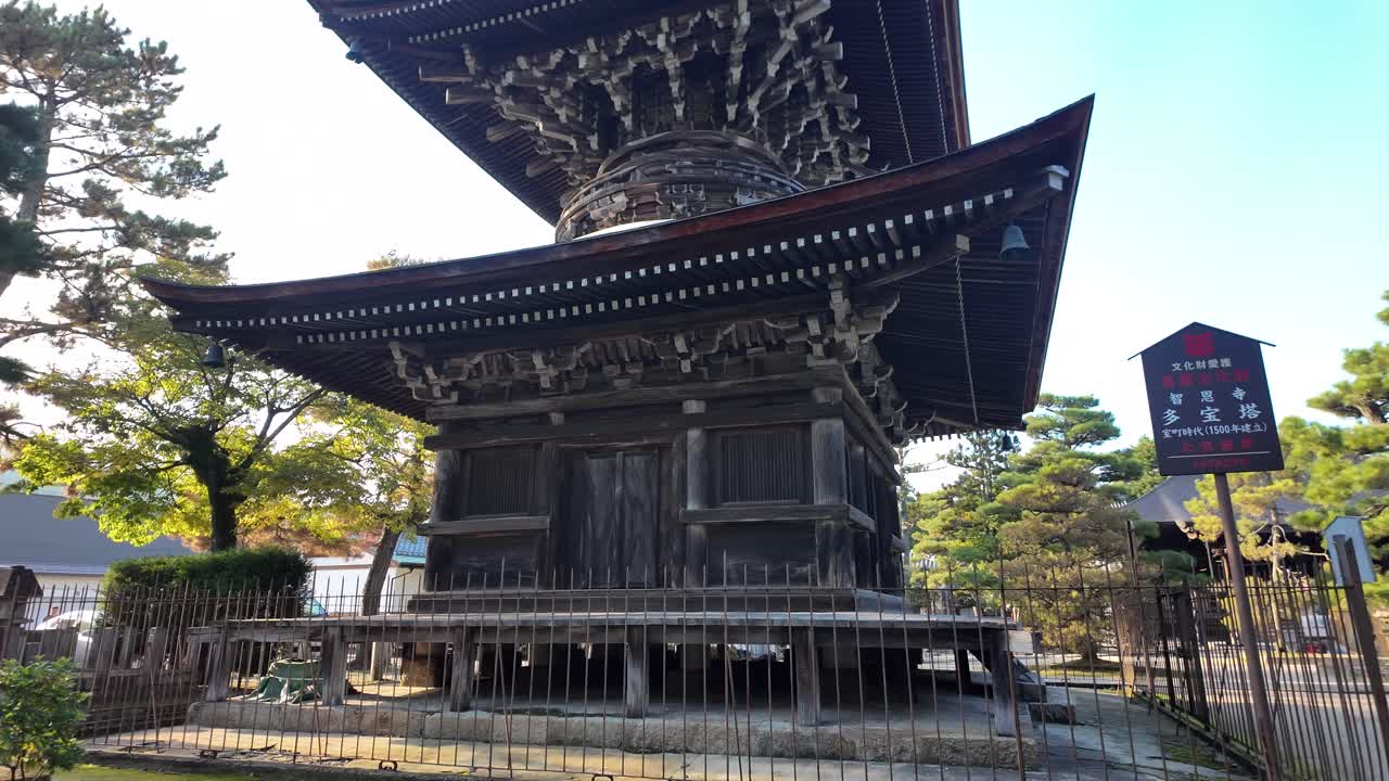 Ancient wooden pagoda of Chionji Temple rising majestically against a backdrop of lush greenery in Amanohashidate, Japan
