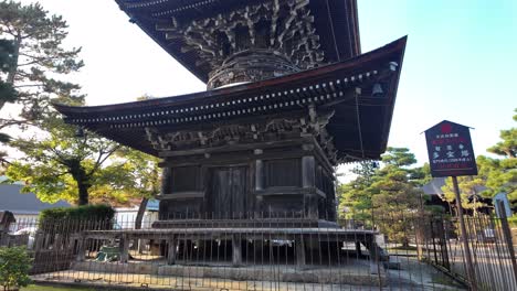 Ancient wooden pagoda of Chionji Temple rising majestically against a backdrop of lush greenery in Amanohashidate, Japan