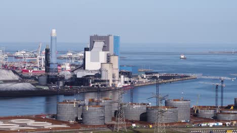 industrial port complex with power plant and oil tanks