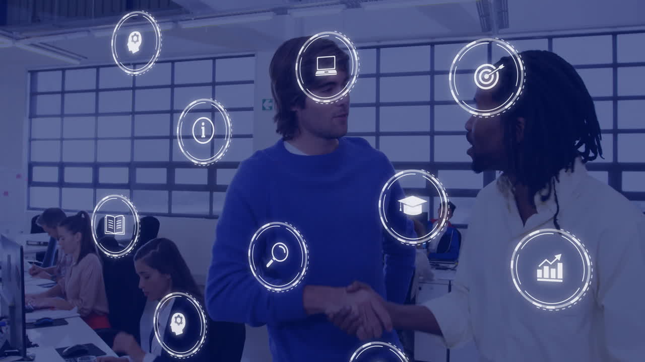 Animation of business icons over diverse business people discussing work