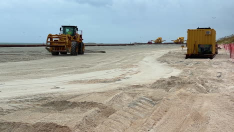beach nourishment project: heavy machinery on the coast