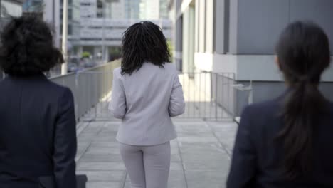 back view of businesswomen walking on street