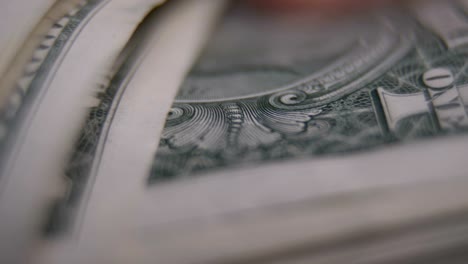 man's hands counting one dollars banknotes