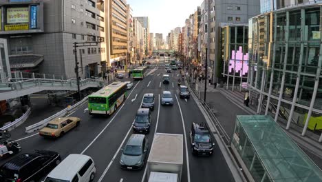 vehicles moving through a busy tokyo intersection