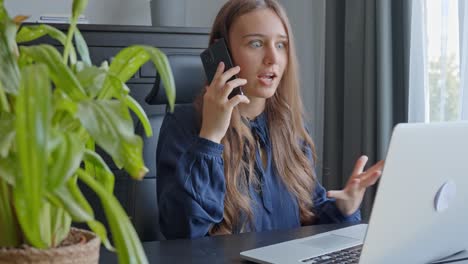 young woman in the office arguing over the phone, in slow motion