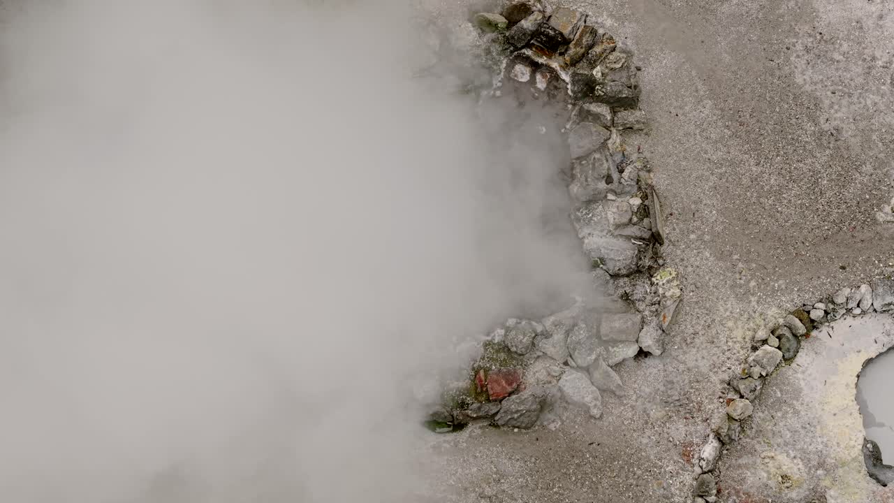 Aerial view of boiling geothermal pool with steam Furnas Sao Miguel Azores