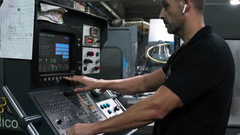 a man operating a cnc machine in a factory