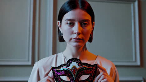 woman holding a mask