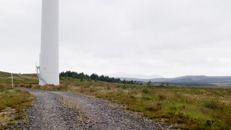 Dynamic-shot-of-a-wind-turbine-spinning-its-blades-on-a-gusty-day