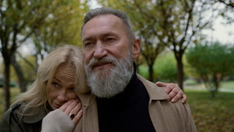 cheerful elderly couple enjoying each other in park