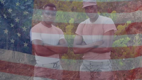 Animation-of-flag-of-america-waving-over-african-american-soldiers-standing-arms-crossed