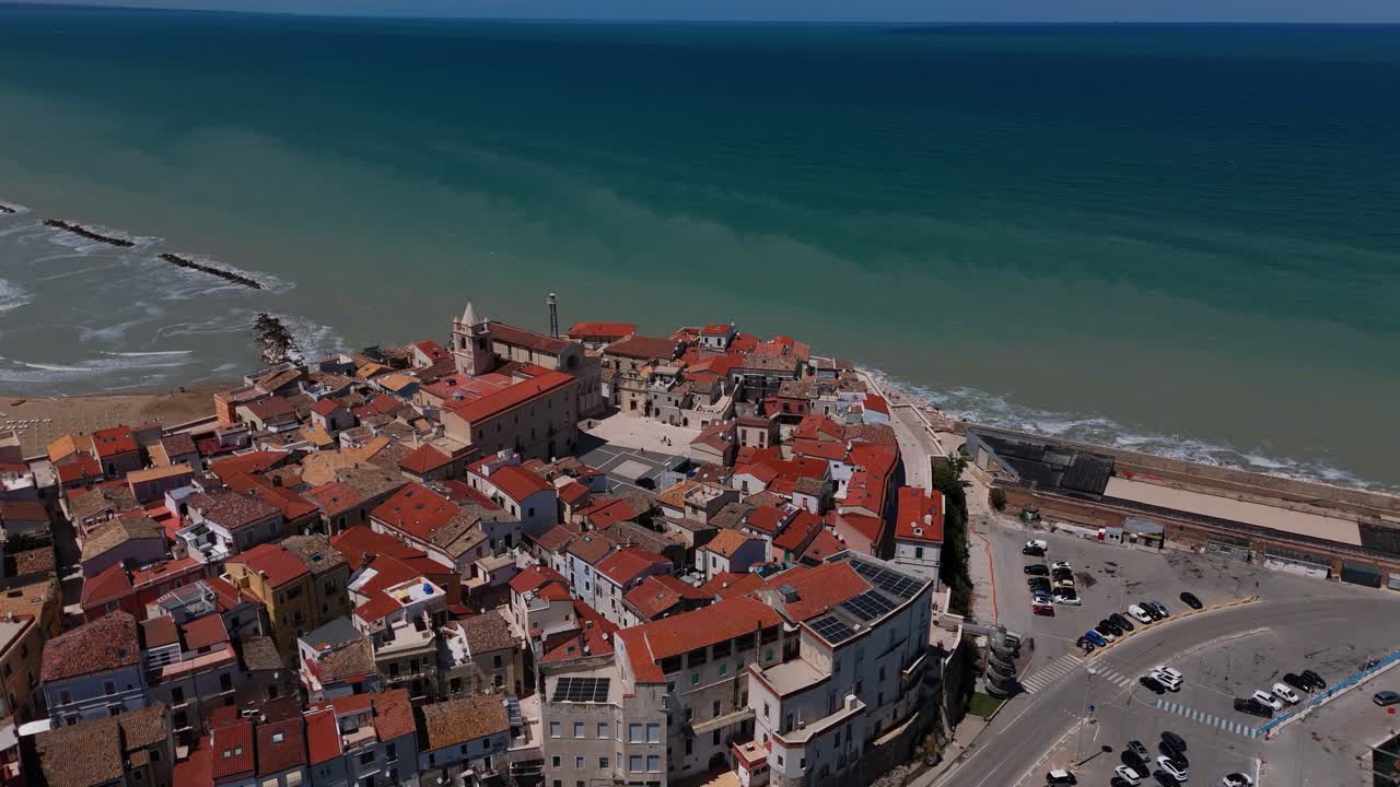 Termoli fortified old town aerial. Puglia, Italy aerial. Colorful rooftops, deep blue sea and beaches