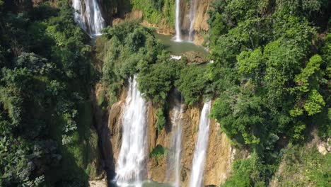 an adventurous drone shot, flying toward thi lo su waterfall, located off the beaten track in the backpacker's paradise country of thailand in the area of umphang in southeast asia