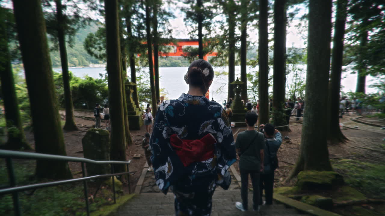 Woman in Yukata Walking Towards Torii Gate