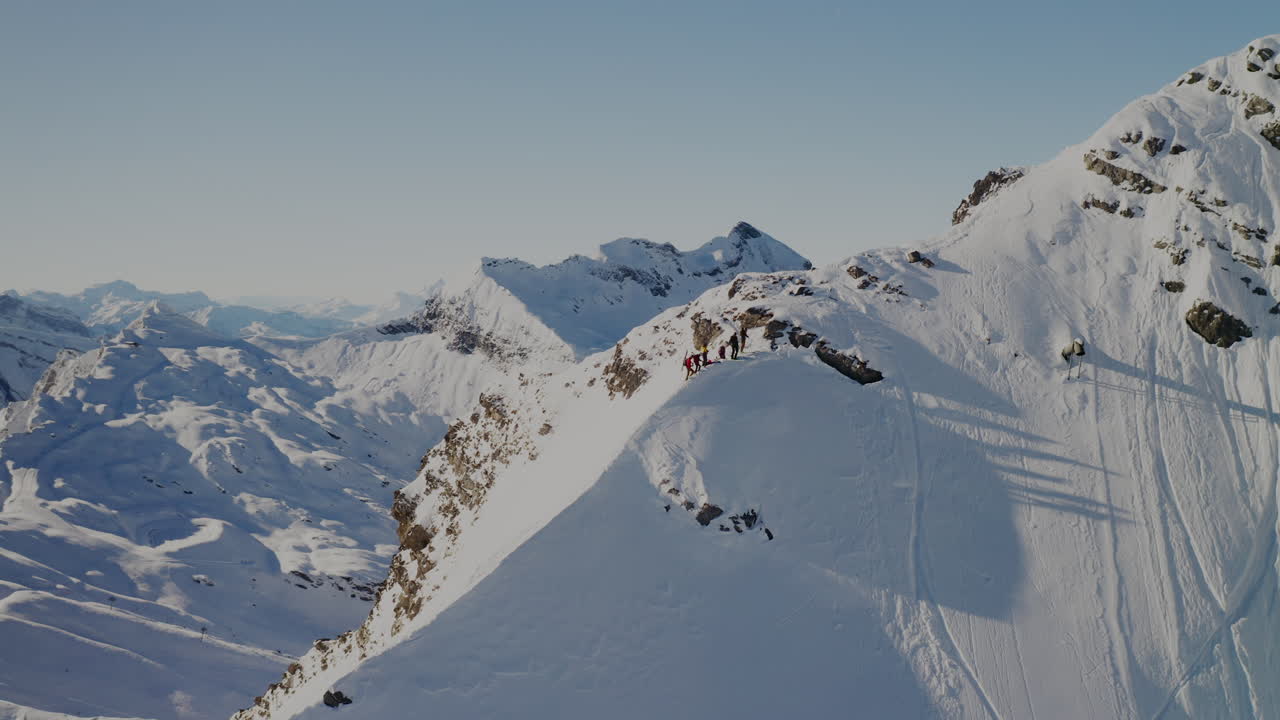 Freeride skier skinning up with Dents du Midi backdrop, then charging steep powder on a bluebird day near Champéry and Avoriaz.